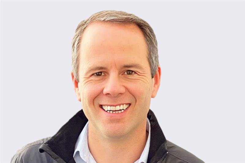 Mark Woods, MitoQ Chief Financial Officer, wearing a dark jacket over a light shirt on a plain background