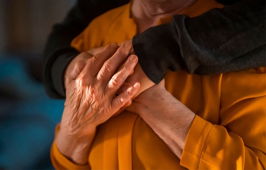 Elderly couple holding hands