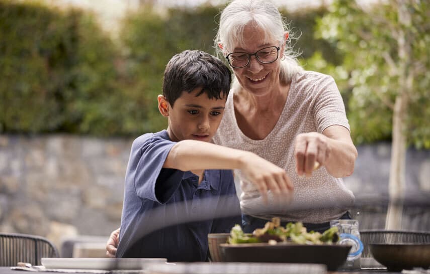Grandmother and son serving dinner