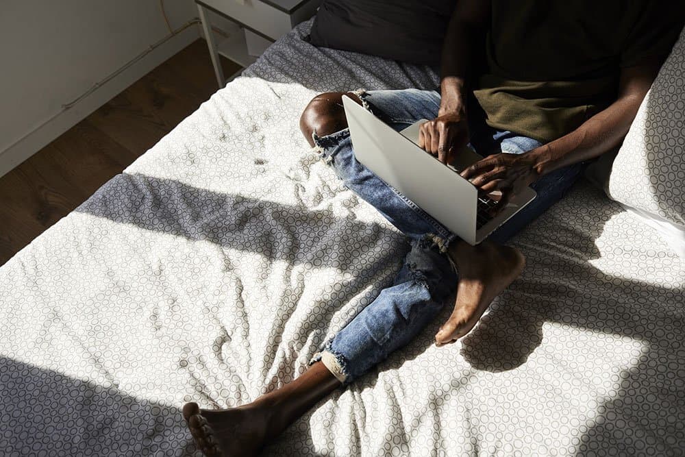 Working on laptop on a bed