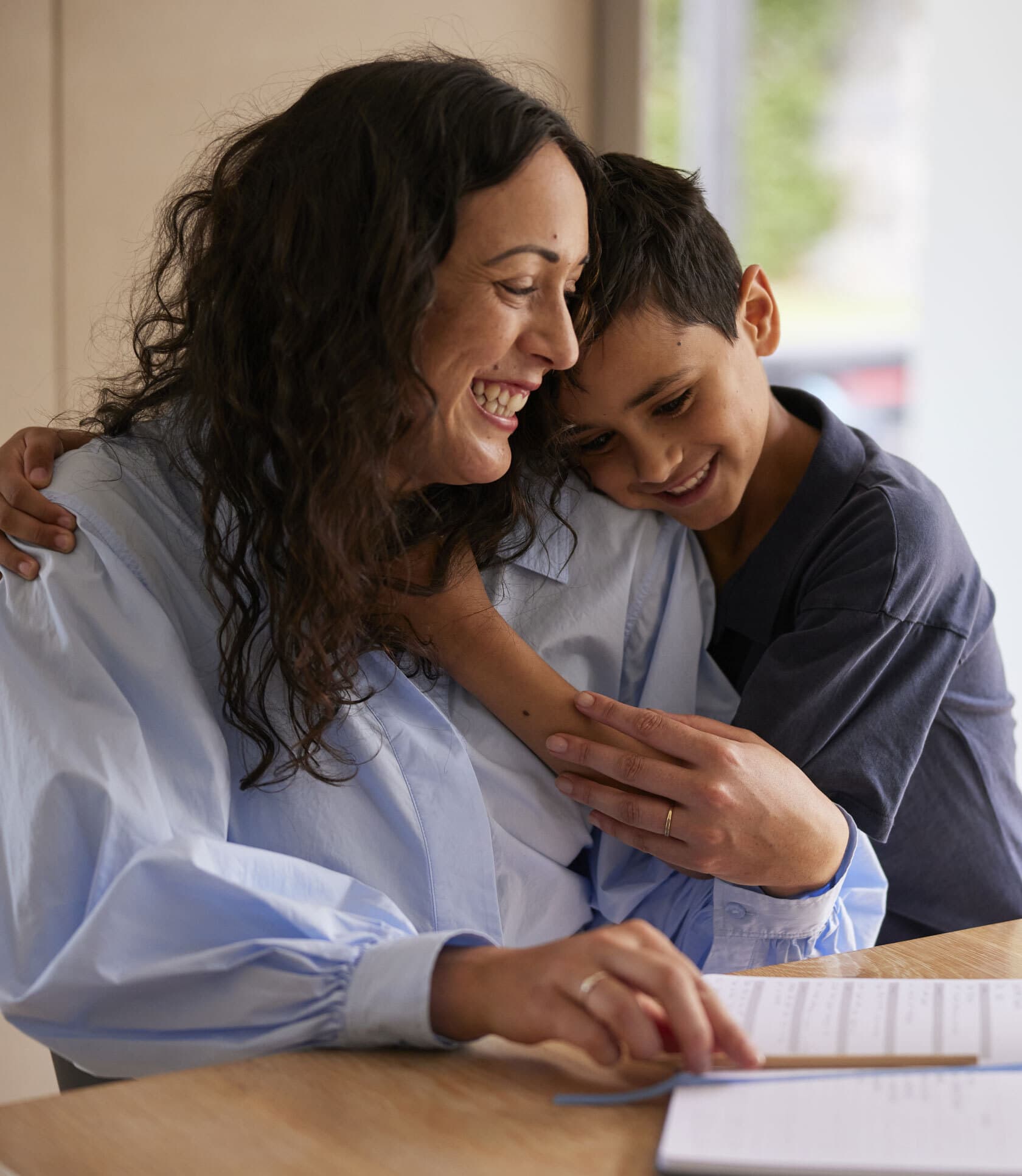 Woman working and hugging child