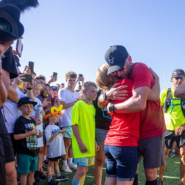 iron cowboy celebrating hugging