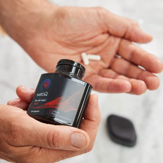 person taking 2 capsules of mitoq pure