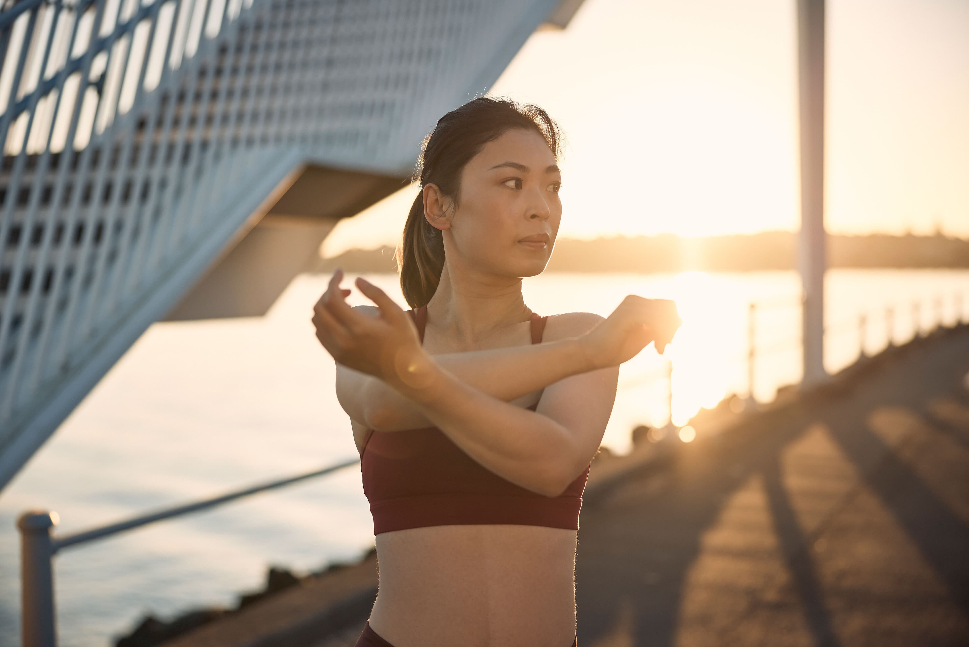 Woman stretching at sunrise