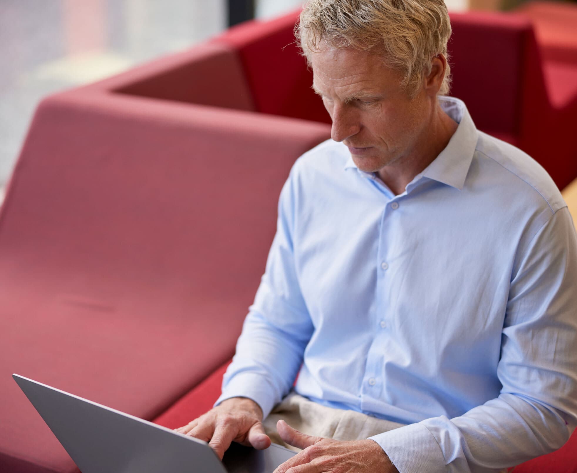 a productive man sitting and working at his laptop