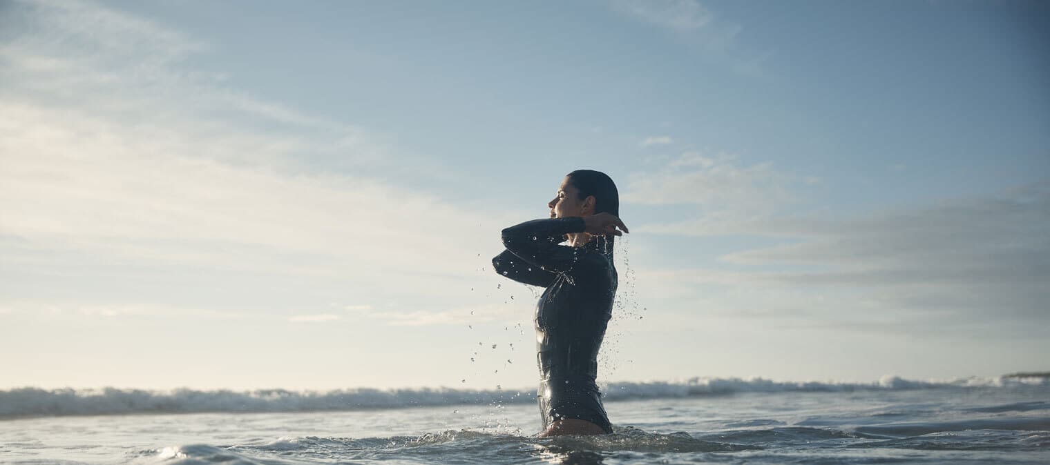 woman swimming in the surf