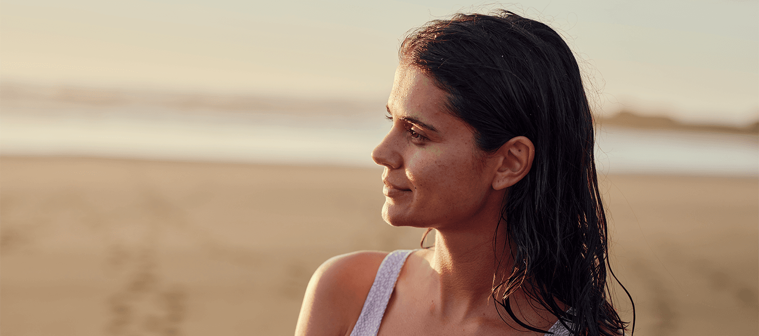 Lady on beach looking into view