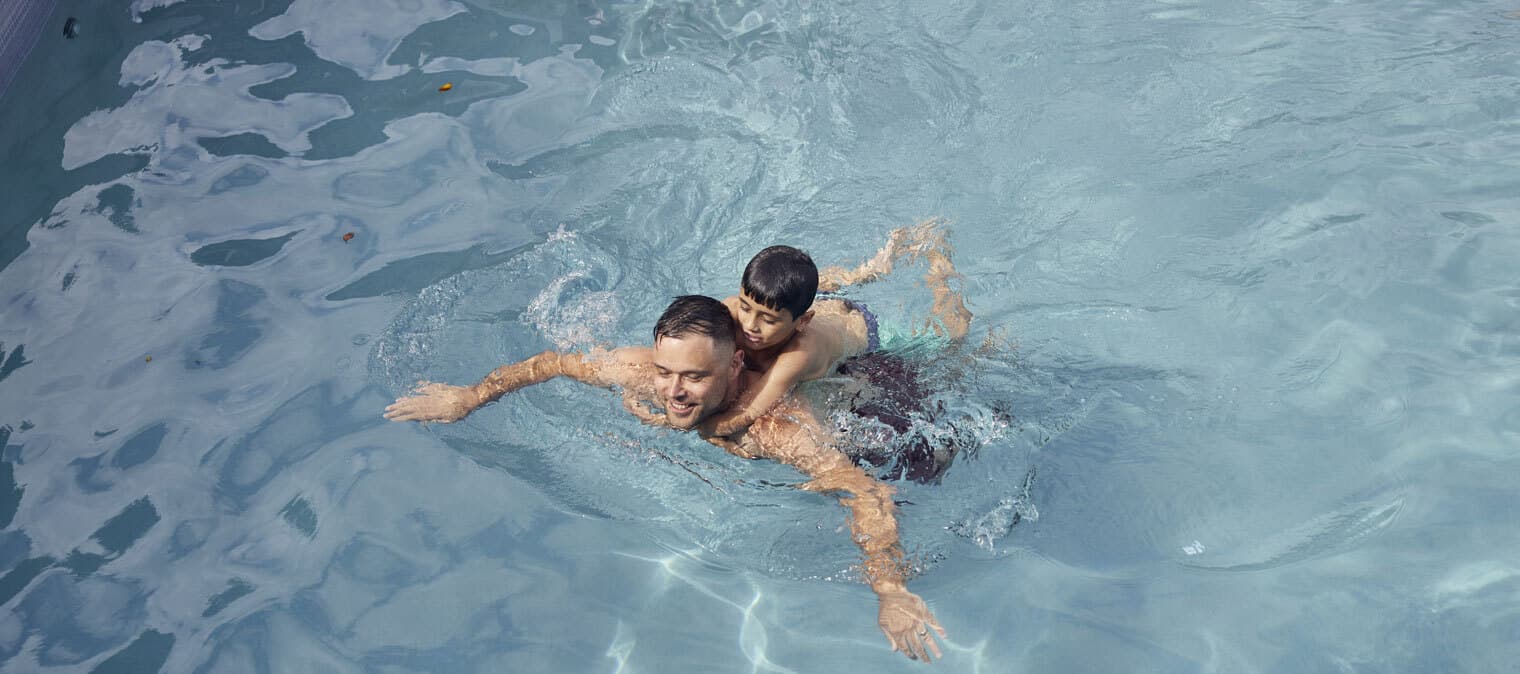 Dad and son in swimming pool