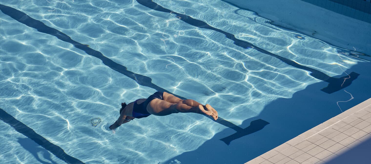 Woman diving into swimming pool