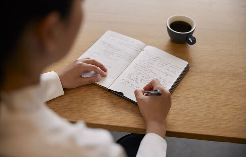 Woman writing in notebook