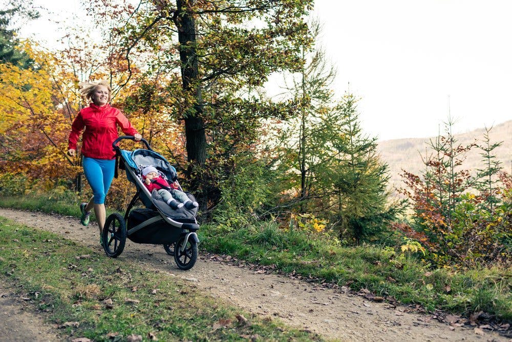 Mother running with baby in pram
