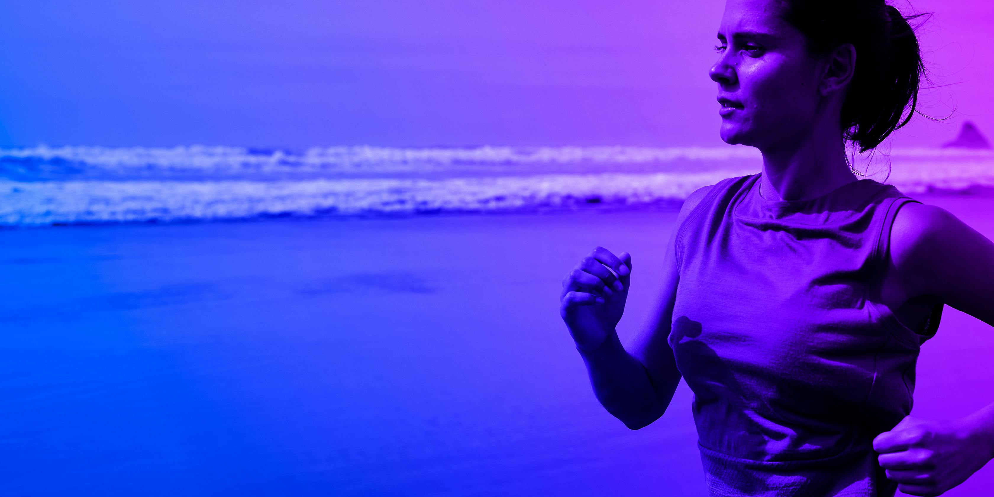 Lady running on beach with blue gradient filter