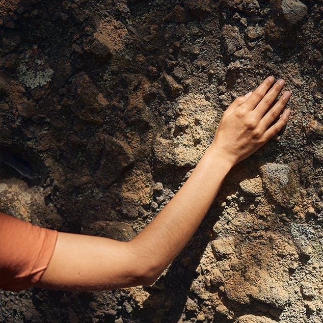 Close up of hand on rock wall