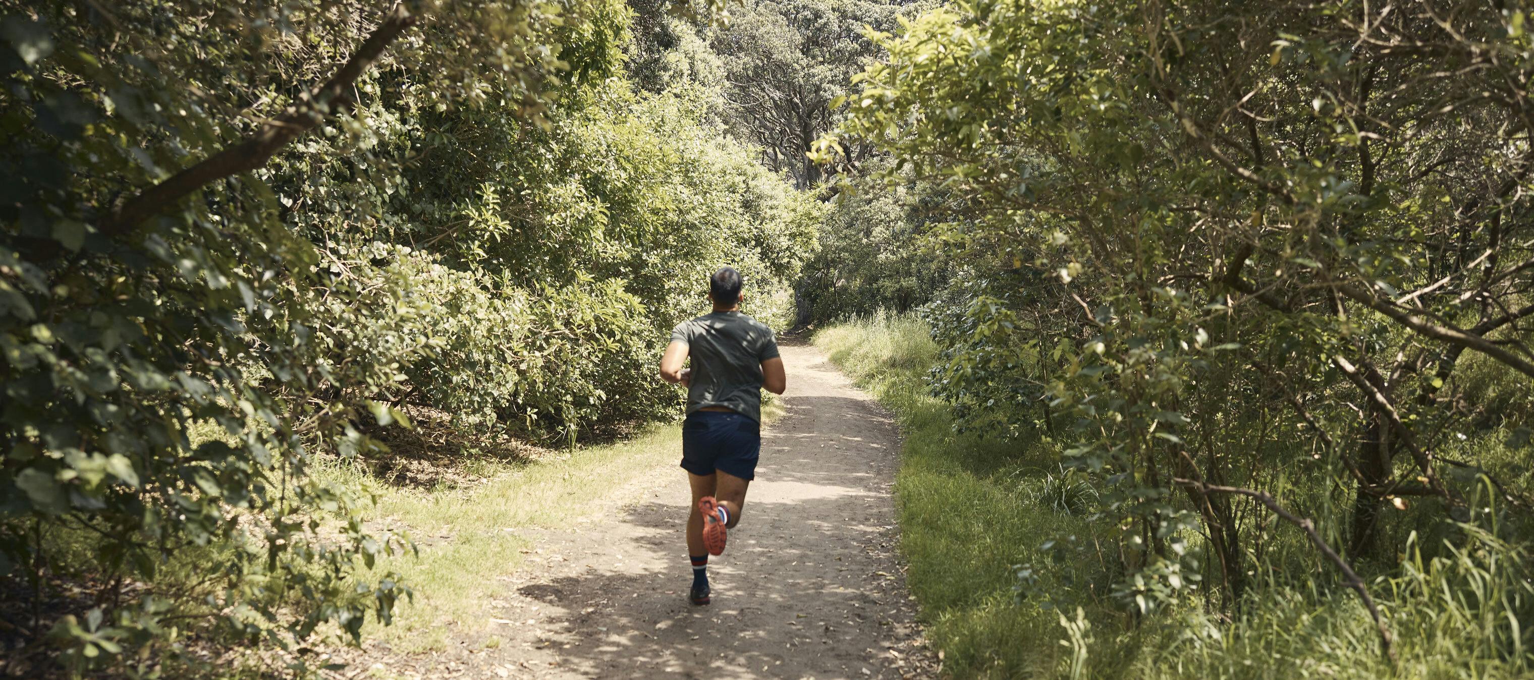 a person jogging through the woods outside