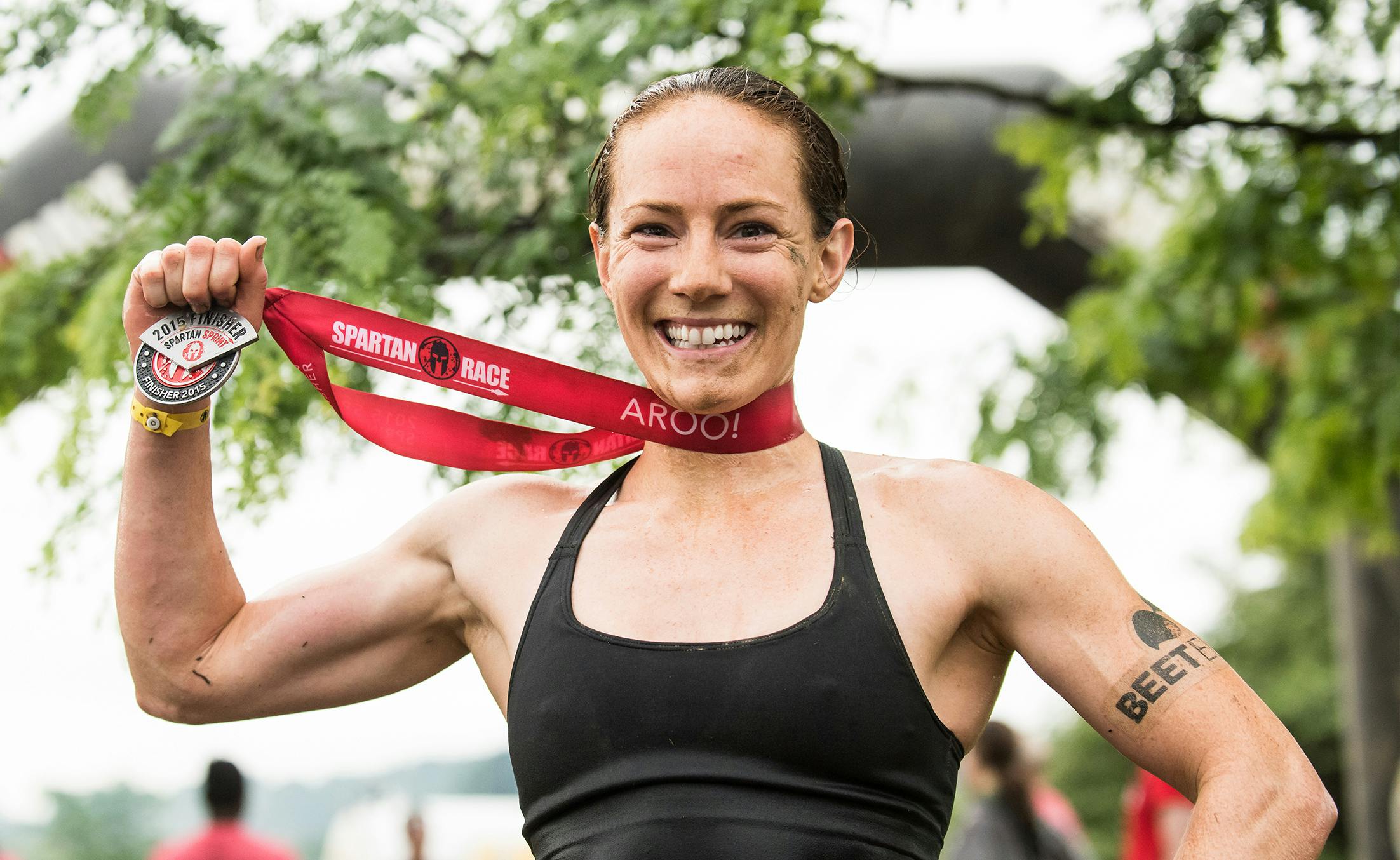 Rose Wetzel, a Spartan obstacle course racer, smiling and holding her medal