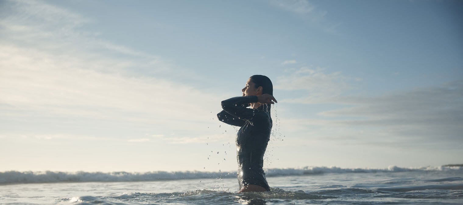 woman swimming in the surf