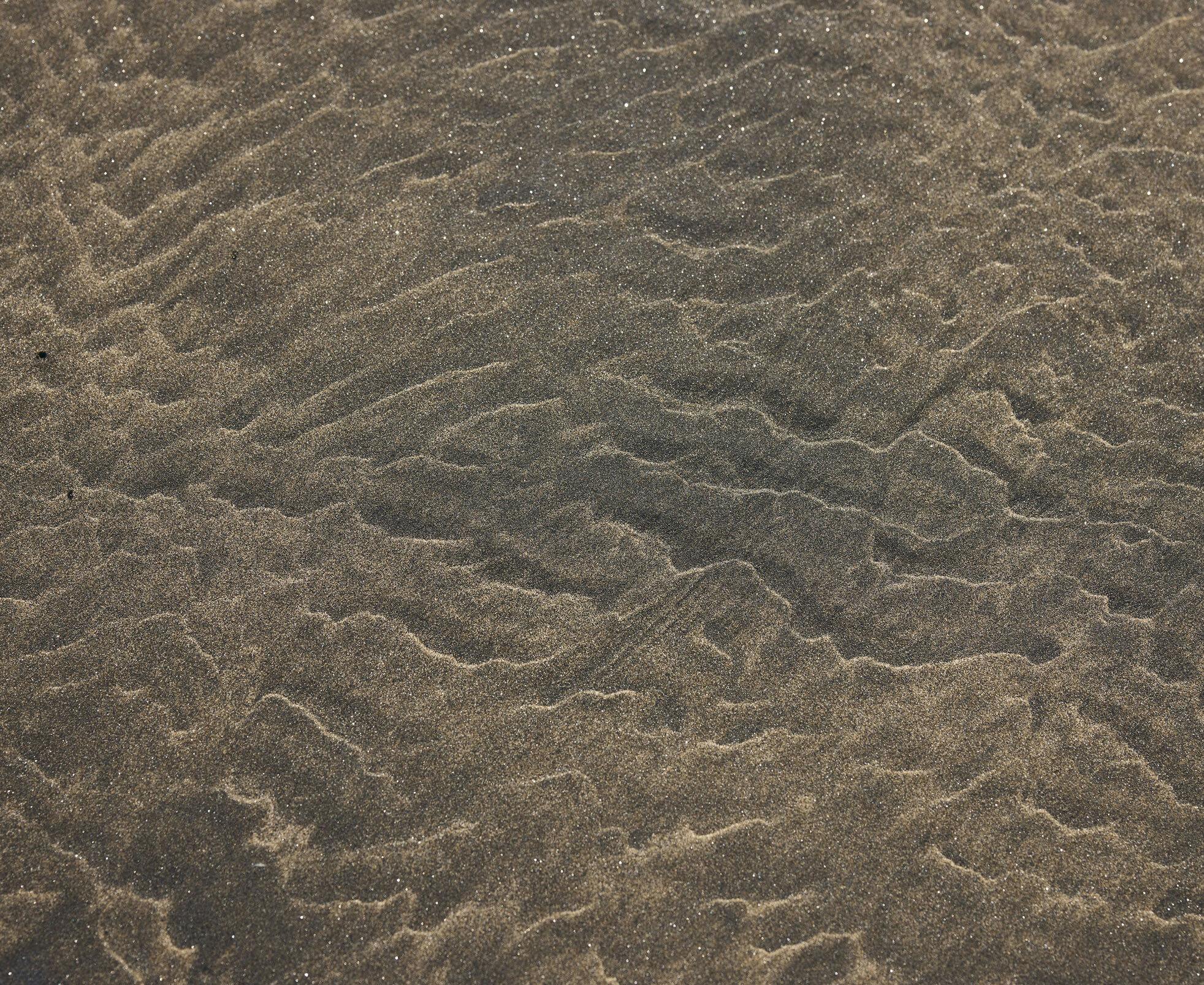 image of ripples in the sand under water