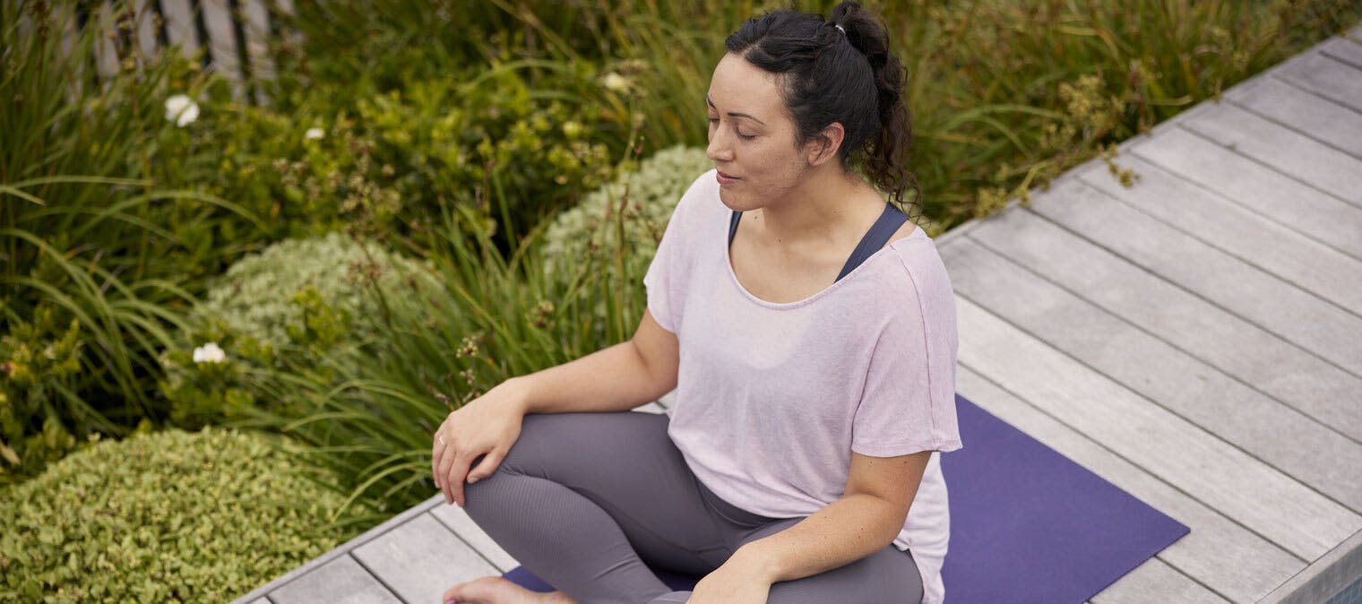 Woman meditating on a yoga mat