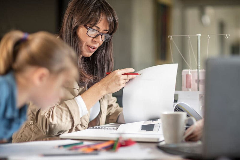 Woman working next to child