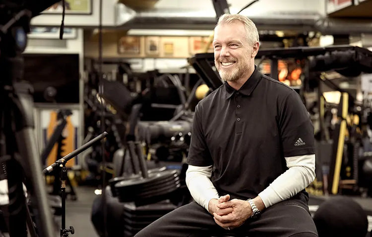 Gunnar Peterson sitting in a gym wearing an Adidas shirt talking about taking MitoQ