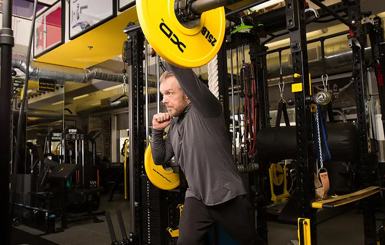 Gunnar Peterson using gym equipment in a fitness center