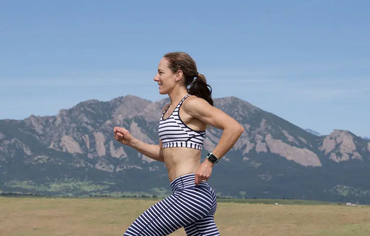 Rose Wetzel running outdoors with mountains in the background
